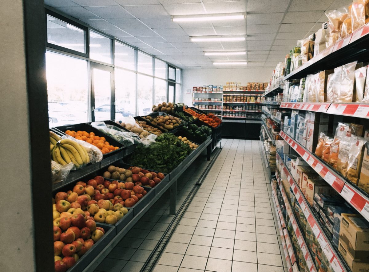 Fresh produce aisle with apples, oranges and vegetables