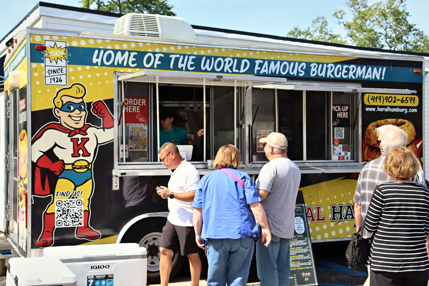 Customers lined up at the Koral Hamburg food truck window during the 100-year celebration